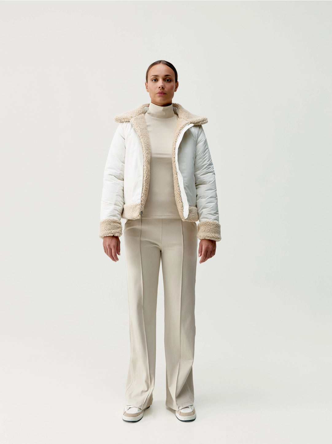 Modell med vit jacka helkroppsbild